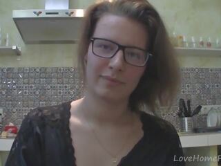 Solo darling with glasses chatting in the kitchen