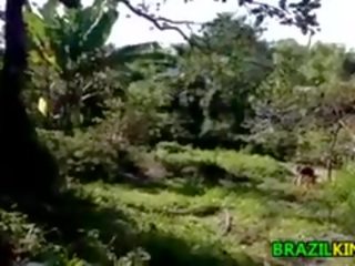 Poor brazilian washing her body outdoors