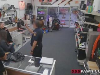 A couple girls and a cop in a shop