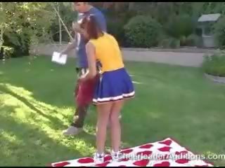 Attractive erotic redhead cheerleader showing tits